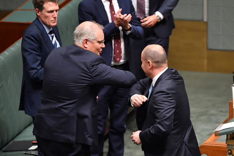 Scott Morrison and Josh Frydenberg elbow-bump in parliament