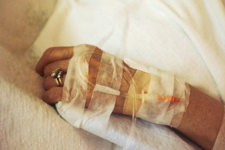 A closeup of an IV in a patient's hand.