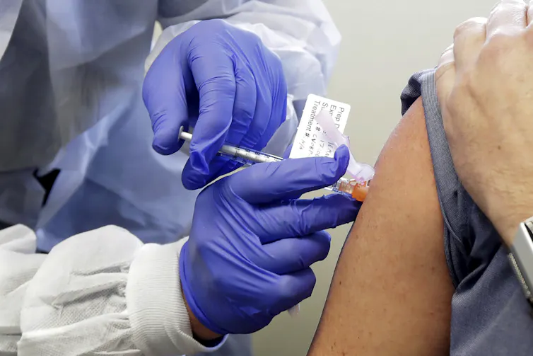 Arm being injected with trial vaccine