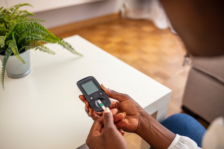 A woman checks her blood sugar level.