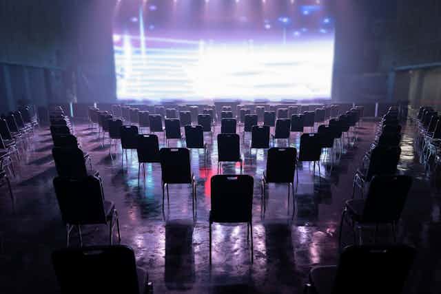 Empty concert venue, with chairs spaced out.