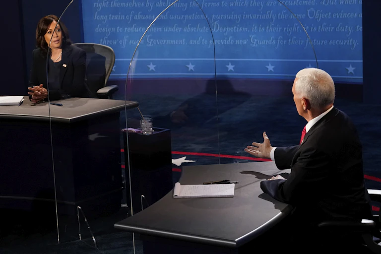 Harris and Pence face each other on the debate stage through plexiglass barrier.