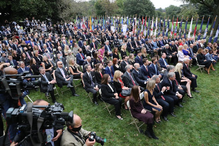 The crowd seated side-by-side in the Rose Garden.