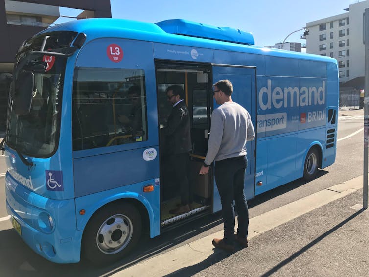 Passenger waiting to board a Bridj on-demand bus service.