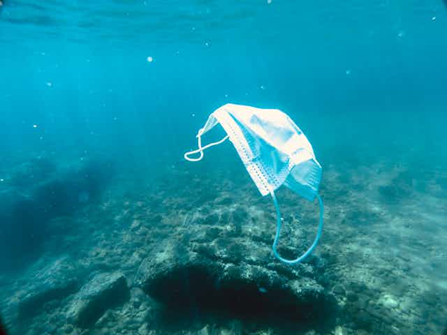 A face mask floating in the ocean