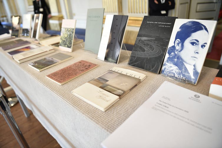 Table in a bookshop displaying books of poetry by American poet Louise Glück