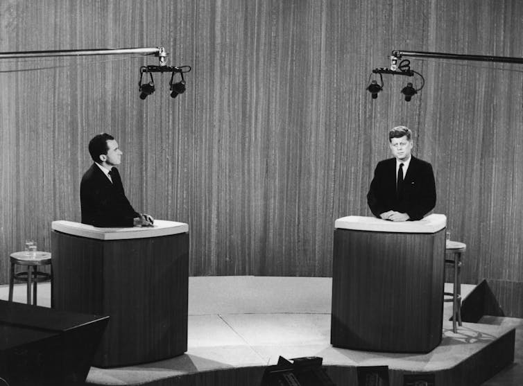 Candidates Richard Nixon and John F. Kennedy in a televised debate.