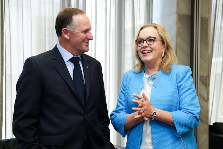 man in suit and woman in blue jacket