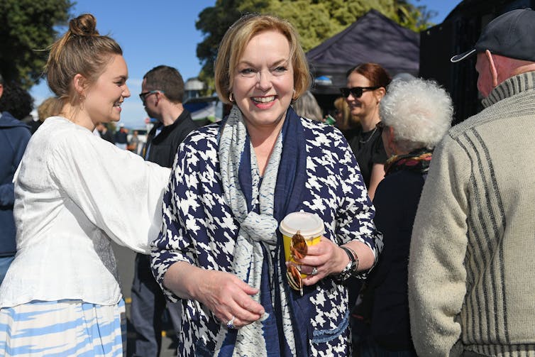 woman with coffee in crowd of people