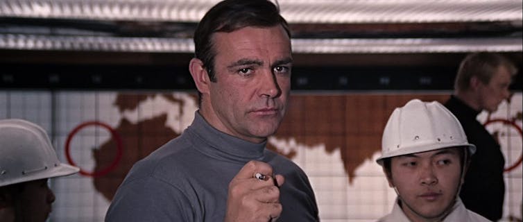 Sean Connery holds a cigarette in You Only Live Twice