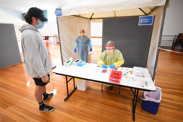 People line up for COVID testing.