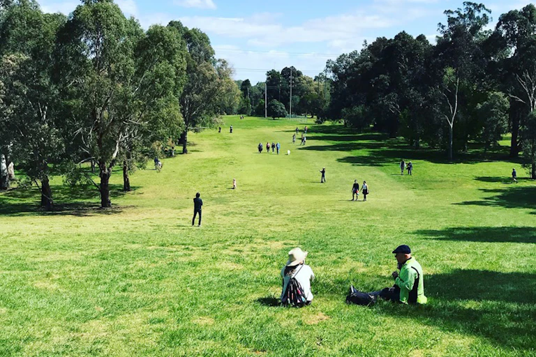 people sitting and walking on golf course
