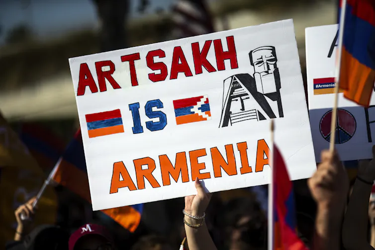 Protester holding up sign which says 'Artsakh is Armenia'.