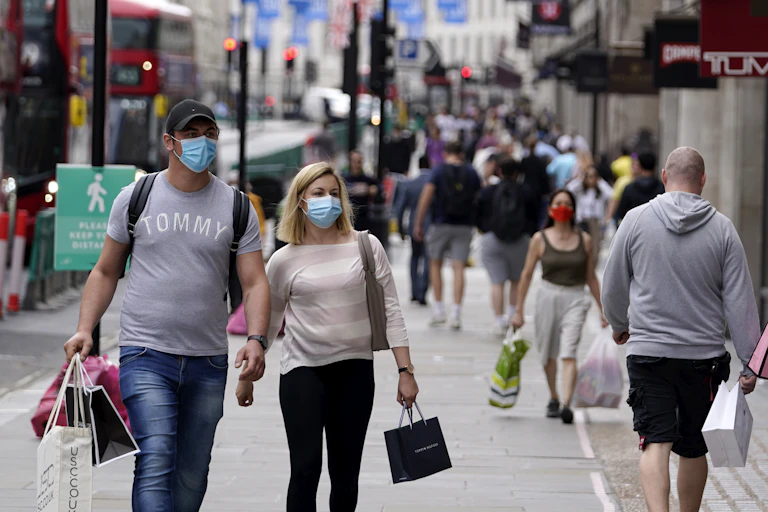 Couple wearing masks on busy shopping street