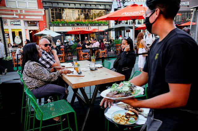 People eating outdoors at a restaurant in San Diego.