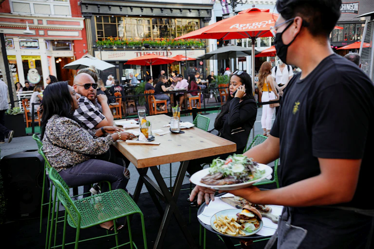 People eating outdoors at a restaurant in San Diego.