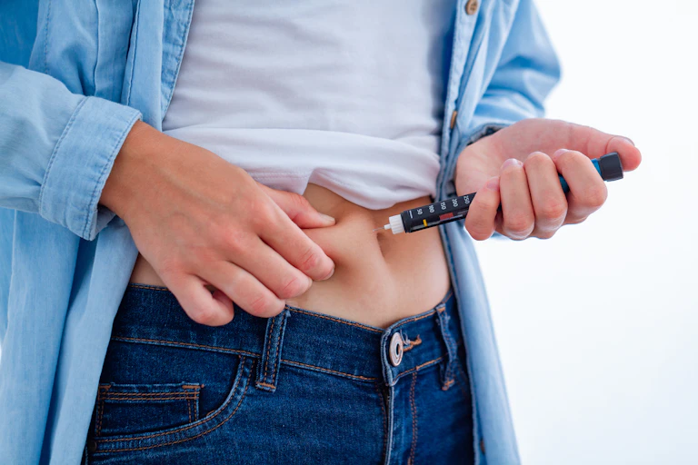 Person with diabetes injecting themselves with insulin