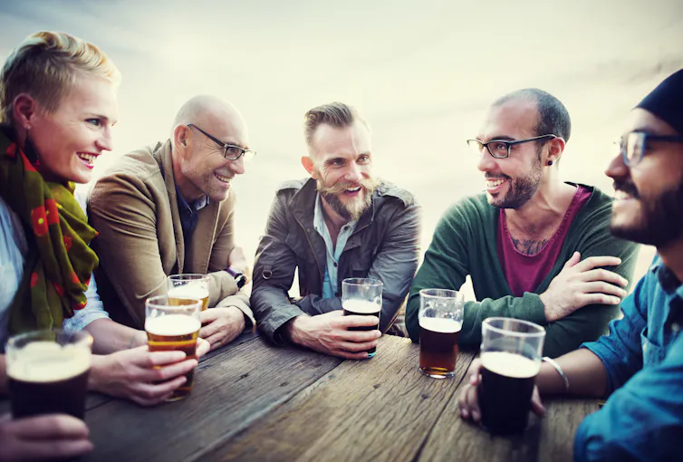 A group of people socialising at a bar.