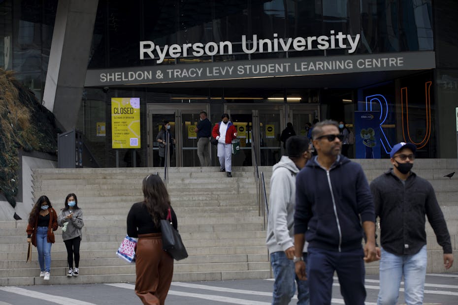 People walk in front of a Ryerson University building.