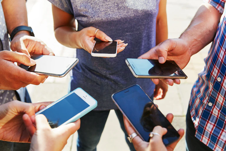 Young people looking at their phones.
