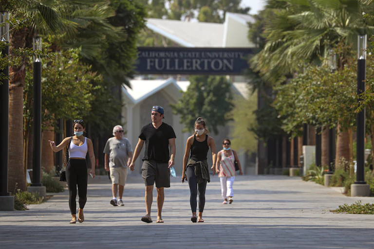 A group of tourists visit a college campus.
