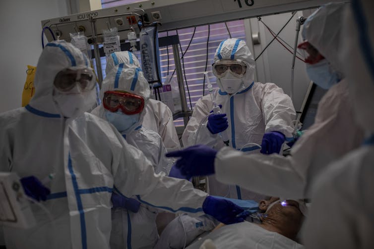 Health-care workers treating a patient in Madrid, Spain.