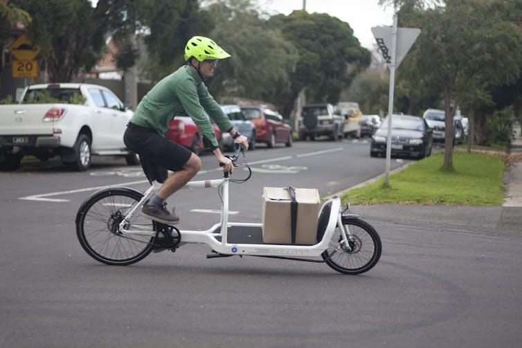 The author riding a cargo bike.