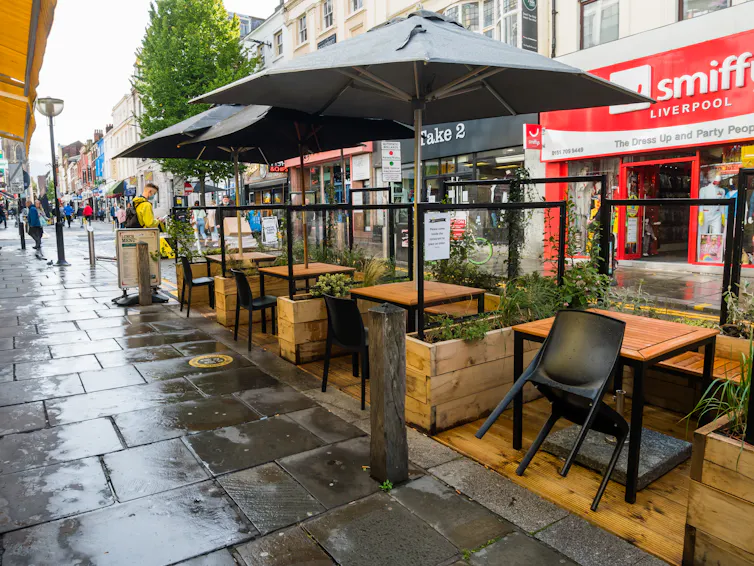 Street with empty outdoor restaurant seating area