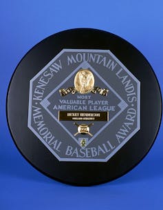Awarded to Oakland Athletics outfielder Rickey Henderson, the 1990 American League Most Valuable Player Award prominently features Kenesaw Mountain Landis' name.