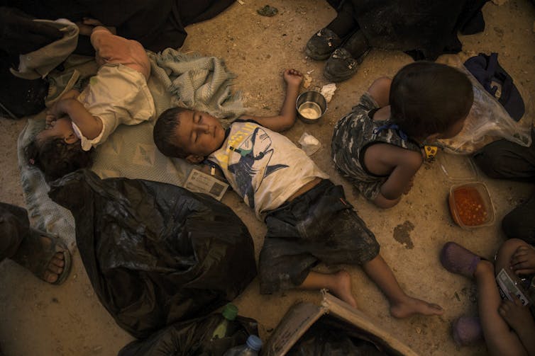 Children sleeping on the ground