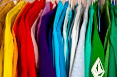 Close-up of shirts of different colors hanging in a closet