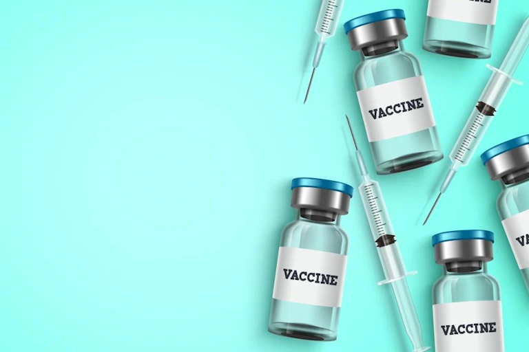 Illustration of vaccine bottles and syringes laid flat on a blue surface
