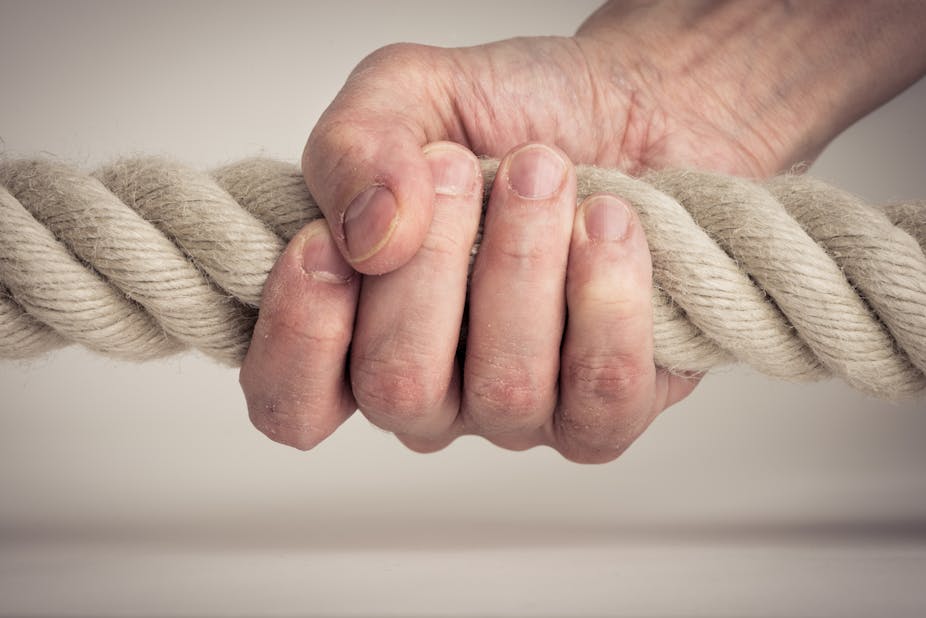 Person grips a rope tightly.