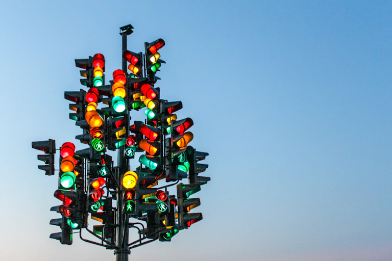 Multiple traffic lights all pointing in different directions.