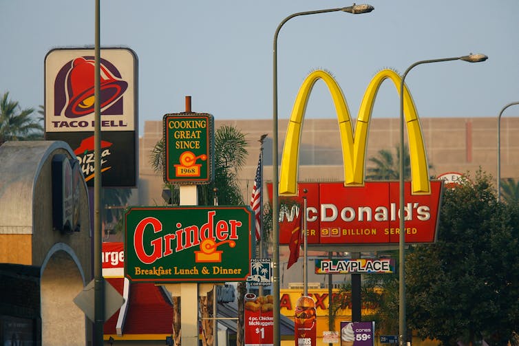 Signs for fast food restaurants along a Los Angeles street.