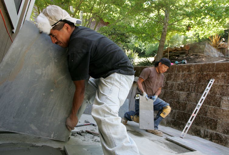 Two landscaping workers.