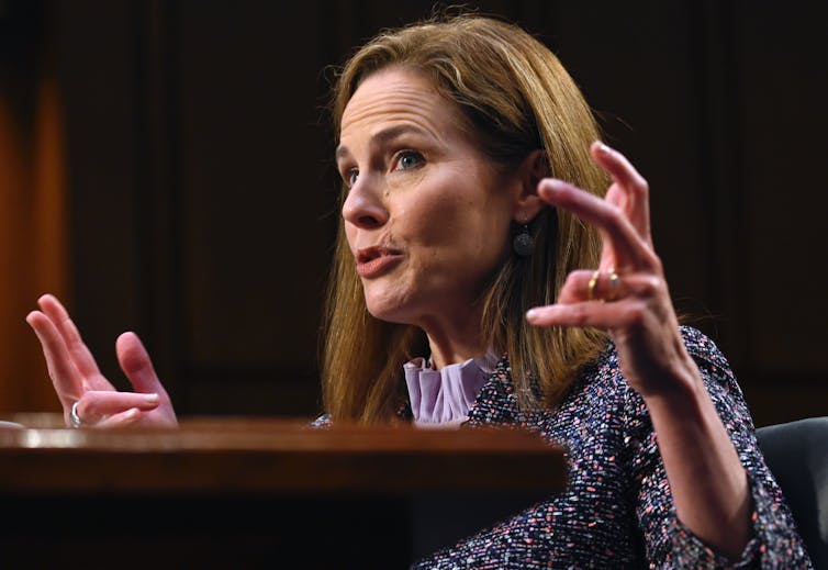 Judge Amy Coney Barrett gesturing with her hands at her confirmation hearing.