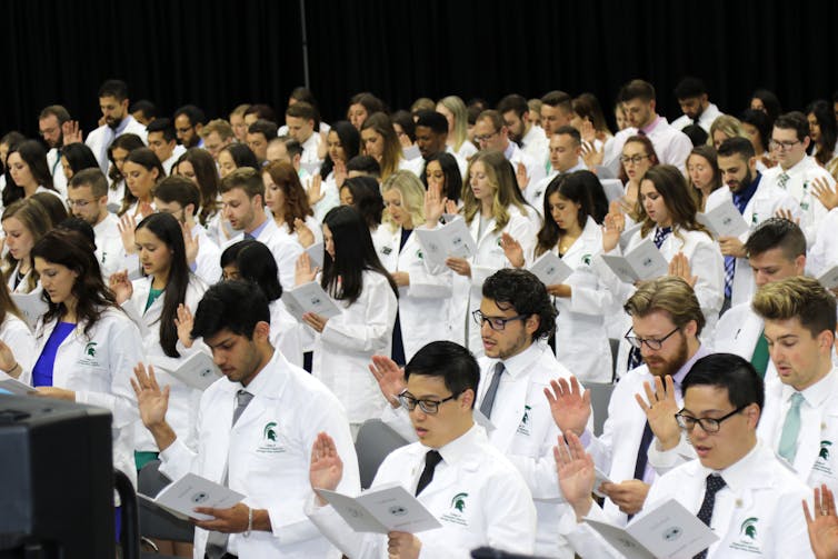 crowd of D.O. students wearing their white coats