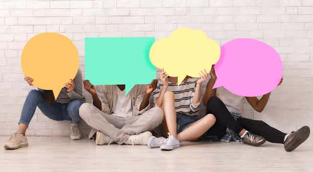 Teens hold speech bubbles in front of their faces.