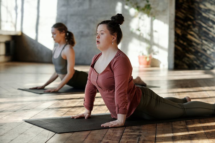A young woman with Down syndrome at yoga class.