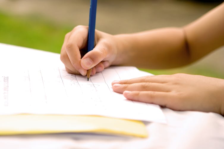 Young child learning to write.