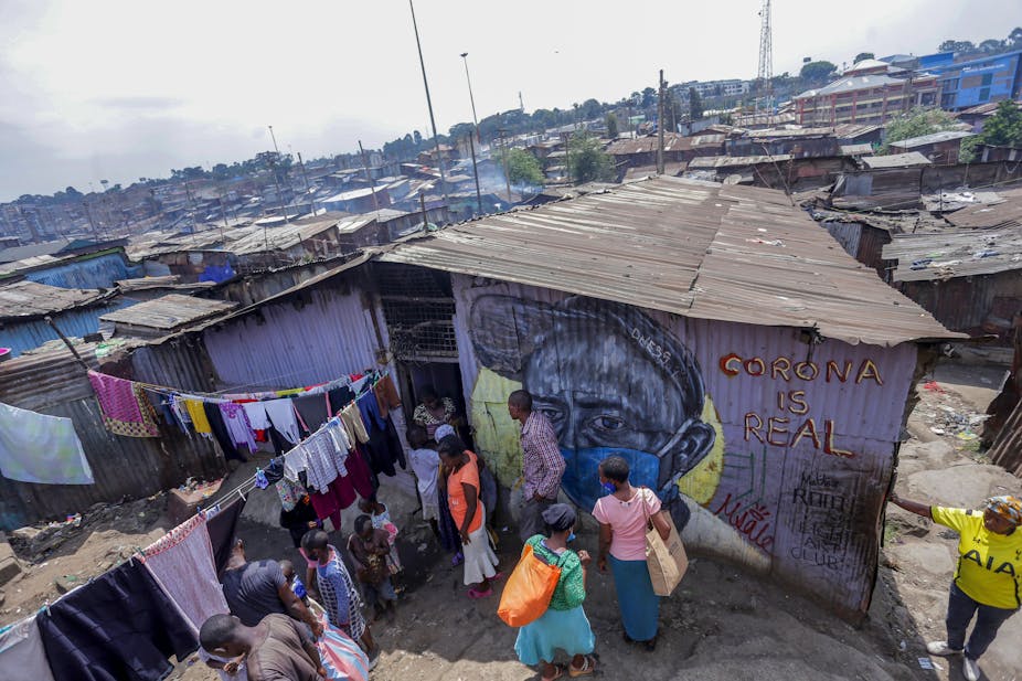 Artwork is seen on the wall of a house in Mathare slums with a man wearing a facemask and words saying coronavirus is real