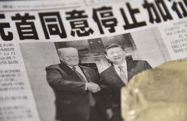 A Chinese newspaper features a front page photograph ofU.S. President Donald Trump shaking hands with Chinese President Xi Jinping.
