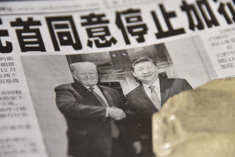 A Chinese newspaper features a front page photograph ofU.S. President Donald Trump shaking hands with Chinese President Xi Jinping.