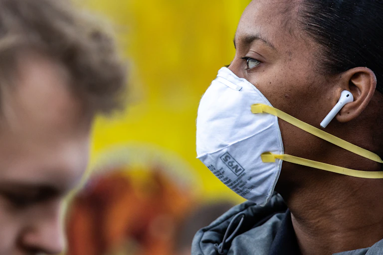 A woman wears a face mask.