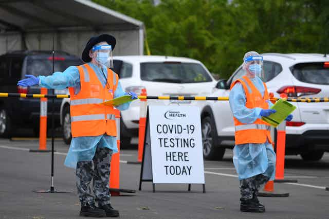 Two Australian Airforce personnel at a drive-through COVID-19 testing centre in Shepparton, Victoria