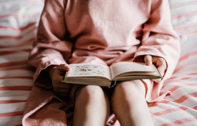 Young girl reads a book