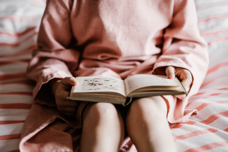 Young girl reads a book