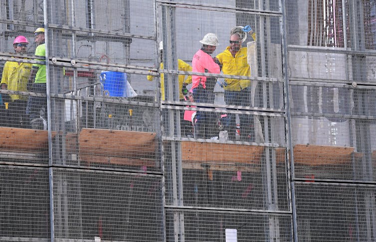 workers on an apartment housing construction site