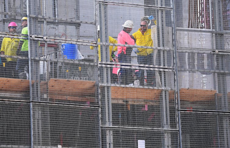 workers on an apartment housing construction site
